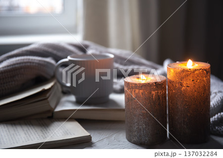 Cozy home composition with candles on a blurred background. Cozy home composition with candles on a blurred background. 137032284