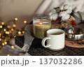 Cozy home composition with a cup of coffee and a candle in a candlestick. 137032286