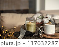Cozy home composition with a cup of coffee and a candle in a candlestick. 137032287
