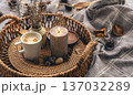 Cozy home composition with a cup of coffee, a candle and decorative details. 137032289