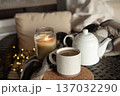 Cup with coffee, kettle and burning candle. 137032290