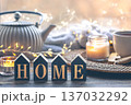 Cozy home composition with a cup of tea, candles and a teapot. 137032292