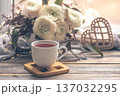 Cozy home composition with a cup of tea and flowers. 137032295