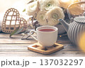Cozy home composition with a cup of tea, teapot and flowers. 137032297