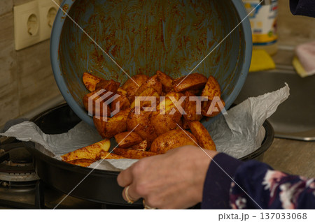 Transferring Spiced Potato Wedges to Baking Tray Preparation Transferring Spiced Potato Wedges to Baking Tray Preparation 137033068