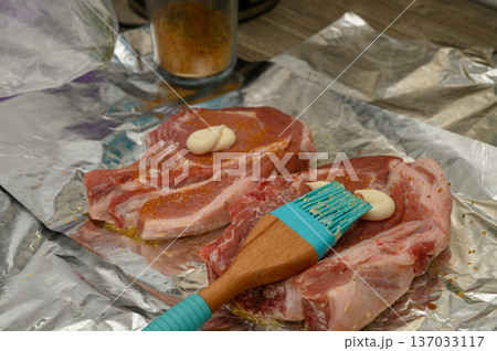 Pork Chop Marinating Process with Sauce Brush on Foil 137033117