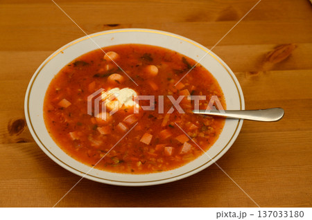 Tomato Lentil Soup with Sausage and Sour Cream on Kitchen Table Tomato Lentil Soup with Sausage and Sour Cream on Kitchen Table 137033180