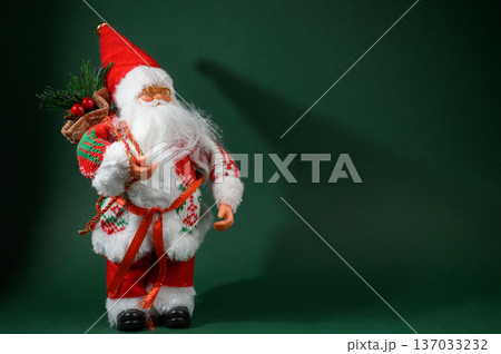Santa Claus with Sack of Gifts on Green Holiday Background 137033232