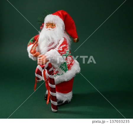 Jolly Santa with Oversized Present Sack on Green Background Jolly Santa with Oversized Present Sack on Green Background 137033235
