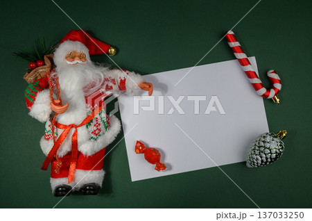 Ded Moroz Figurine Surrounded by Christmas Decorations on Paper 137033250