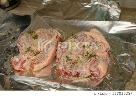 Raw Pork Chops Seasoned Ready for Cooking on Aluminum Foil Raw Pork Chops Seasoned Ready for Cooking on Aluminum Foil 137033257
