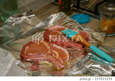 Raw Pork Rib Chops with Herb Seasoning on Aluminum Foil 137033259