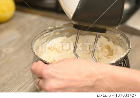 Festive Dough Preparation Hand Mixer in Action for Stollen Festive Dough Preparation Hand Mixer in Action for Stollen 137033427