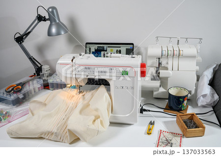 Sewing Studio with Industrial Machine, Overlocker, and Fabric Rolls 137033563