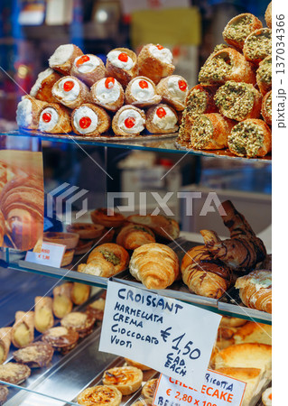 Bakery display with many types of pastries and cakes in a shop window 137034366