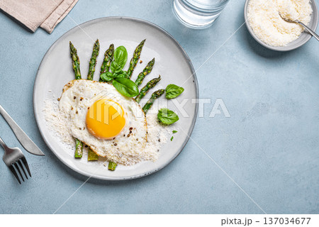 Fried egg with green asparagus and grated parmesan cheese for healthy breakfast Fried egg with green asparagus and grated parmesan cheese for healthy breakfast 137034677