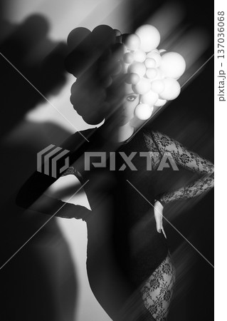 Woman wearing futuristic sphere headpiece in shadow and light Woman wearing futuristic sphere headpiece in shadow and light 137036068