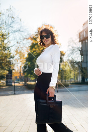 Confident Businesswoman Standing In Sunglasses Near Glass Office Architecture 137036695