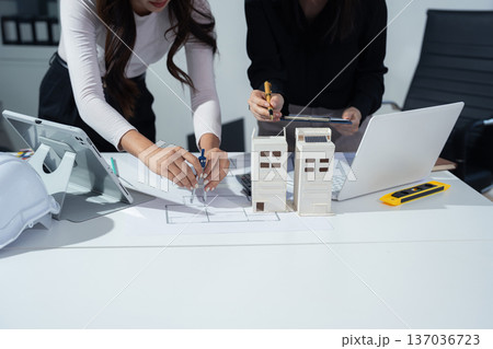 architect asian woman working with colleagues project at construction site at desk in office. architect asian woman working with colleagues project at construction site at desk in office. 137036723
