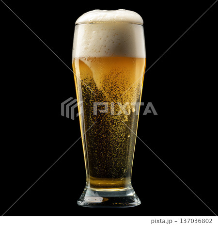 Foamy amber ale beer in a tall glass with creamy foam head, isolated on black background, concept of refreshment and taste Foamy amber ale beer in a tall glass with creamy foam head, isolated on black background, concept of refreshment and taste 137036802