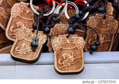Hand-carved Chinese Lunar New Year of the Horse wooden keychains with traditional motif 137037342