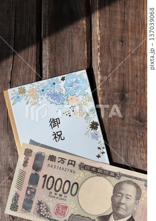 水色で花柄のご祝儀袋と新札の一万円 水色で花柄のご祝儀袋と新札の一万円 137039068