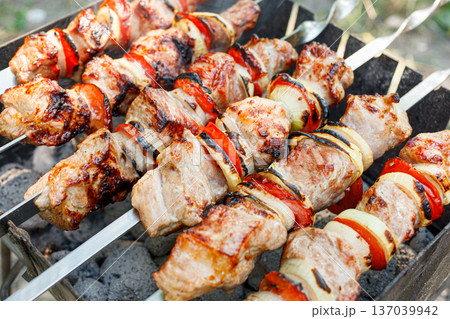Cooking barbecue with vegetables on skewers. Roasted meat on the grill 137039942