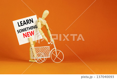 Learn something new symbol. Concept words Learn something new on beautiful white paper on clothespin. Beautiful orange background. Business motivational learn something new concept. Copy space. 137040093