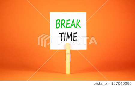 Break time symbol. Concept word Break time on beautiful white paper. Beautiful wooden clothespin. Beautiful orange background. Business break time concept. Copy space. Break time symbol. Concept word Break time on beautiful white paper. Beautiful wooden clothespin. Beautiful orange background. Business break time concept. Copy space. 137040096