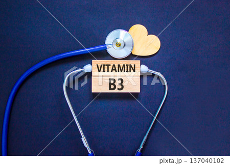 Vitamin B3 niacin symbol. Concept words Vitamin B3 on beautiful wooden blocks. Wooden heart and stethoscope. Beautiful black background. Medical healthy lifestyle Vitamin B3 niacin concept. 137040102
