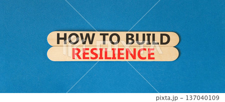 How to build resilience symbol. Concept words How to build resilience on beautiful wooden sticks. Beautiful blue background. Business how to build resilience concept. Copy space. 137040109