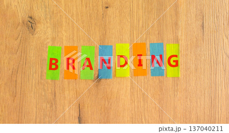 Branding brand word symbol. Concept word Branding on beautiful colored papers. Beautiful wooden background. Business support help branding brand word concept. Copy space. 137040211