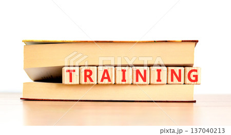 Training word symbol. Concept word Training on beautiful wooden blocks in beautiful book. Beautiful wooden table white background. Business support help training word concept. Copy space. 137040213