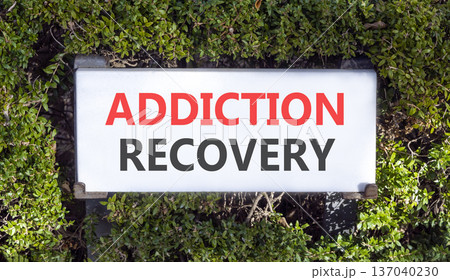 Addiction recovery symbol. Concept words Addiction recovery on beautiful big white sign plate. Beautiful green garden background. Psychology addiction recovery concept. Copy space. Addiction recovery symbol. Concept words Addiction recovery on beautiful big white sign plate. Beautiful green garden background. Psychology addiction recovery concept. Copy space. 137040230
