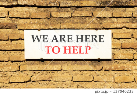 Support, help and we are here to help symbol. Concept words We are here to help on beautiful white marble sign plate. Beautiful brick wall background. Business we are here to help concept. Copy space. Support, help and we are here to help symbol. Concept words We are here to help on beautiful white marble sign plate. Beautiful brick wall background. Business we are here to help concept. Copy space. 137040235