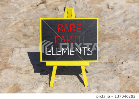 Rare earth elements symbol. Concept words Rare earth elements on beautiful blackboard. Beautiful brown stone beach background. Business and rare earth elements concept. Copy space. 137040282