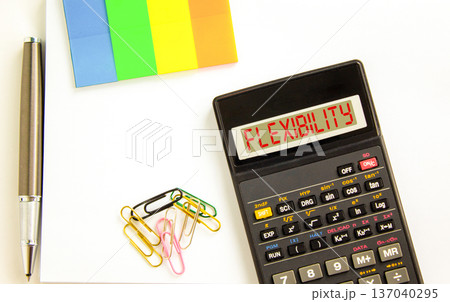 Flexibility symbol. Concept word Flexibility on beautiful black calculator's screen. Beautiful white background. Colored paper and black pen. Business flexibility concept. Copy space. Flexibility symbol. Concept word Flexibility on beautiful black calculator's screen. Beautiful white background. Colored paper and black pen. Business flexibility concept. Copy space. 137040295