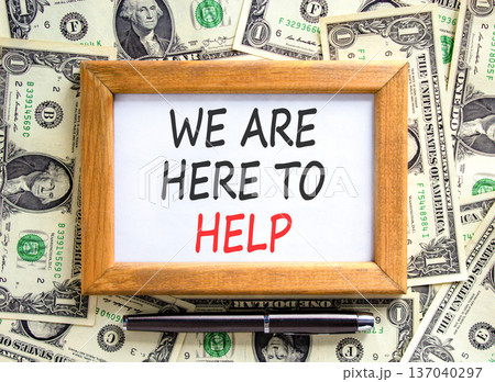 Support, help and we are here to help symbol. Concept words We are here to help on beautiful wooden picture frame. Beautiful dollar bills background. Business we are here to help concept. Copy space. Support, help and we are here to help symbol. Concept words We are here to help on beautiful wooden picture frame. Beautiful dollar bills background. Business we are here to help concept. Copy space. 137040297