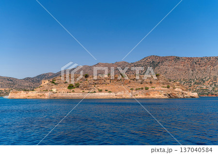Historic fortress on Spinalonga Island in Crete, Greece under clear blue skies Historic fortress on Spinalonga Island in Crete, Greece under clear blue skies 137040584