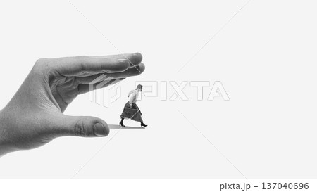 Dramatic poster oversized hand pressing standing man. 137040696