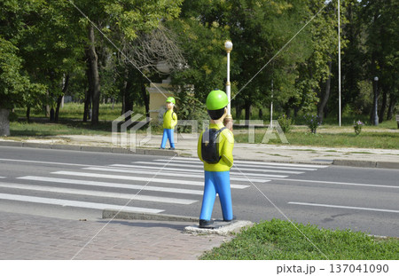 figurine of a boy with a backpack near a pedestrian crossing figurine of a boy with a backpack near a pedestrian crossing 137041090