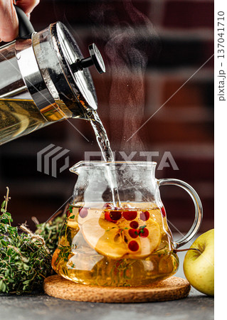 Hot herbal tea with apple and cranberries Hot herbal tea with apple and cranberries 137041710