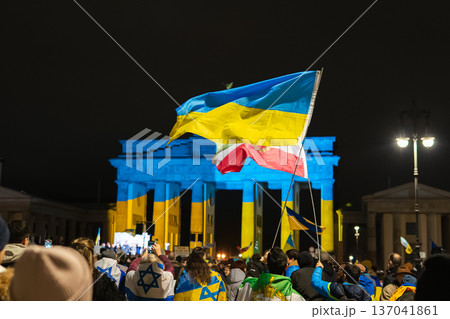Ukrainian and Polish Flags Wave at Brandenburg Gate Lit Blue and Yellow in Berlin Ukrainian and Polish Flags Wave at Brandenburg Gate Lit Blue and Yellow in Berlin 137041861
