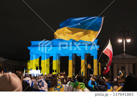 Ukrainian and Polish Flags Wave at Brandenburg Gate Lit Blue and Yellow in Berlin Ukrainian and Polish Flags Wave at Brandenburg Gate Lit Blue and Yellow in Berlin 137041865