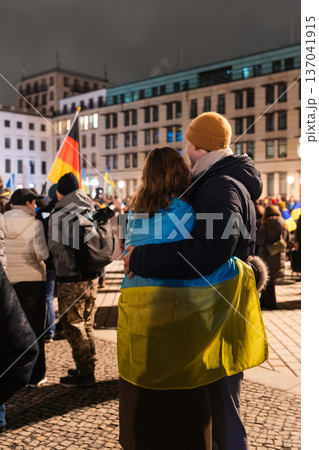 Couple Embraces Under Ukrainian Flag During Pro-Ukraine Night Rally in Berlin Couple Embraces Under Ukrainian Flag During Pro-Ukraine Night Rally in Berlin 137041915