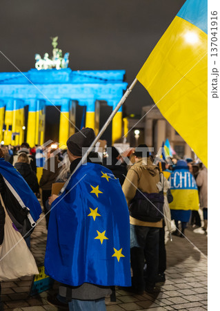 EU Cape and Ukrainian Flag in Front of Brandenburg Gate Lit Blue and Yellow EU Cape and Ukrainian Flag in Front of Brandenburg Gate Lit Blue and Yellow 137041916