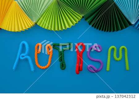 Colorful autism spectrum awareness word with sensory toys 137042312