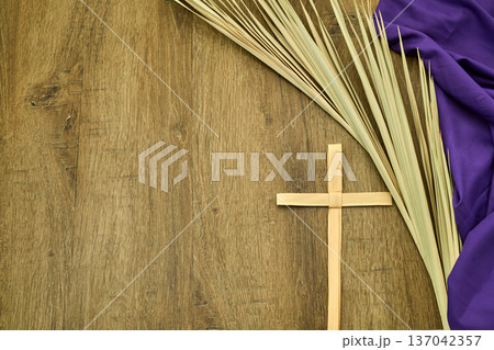 Palm cross, palm fronds, and purple fabric for lent Palm cross, palm fronds, and purple fabric for lent 137042357