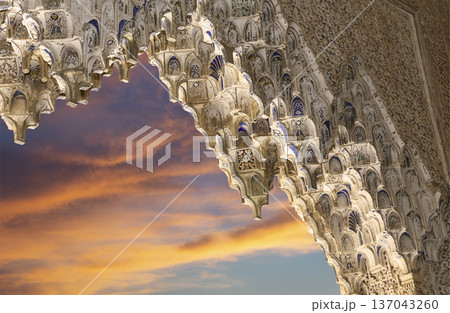Arches in Islamic (Moorish) style (against the sunset) in Alhambra, Granada, Spain 137043260