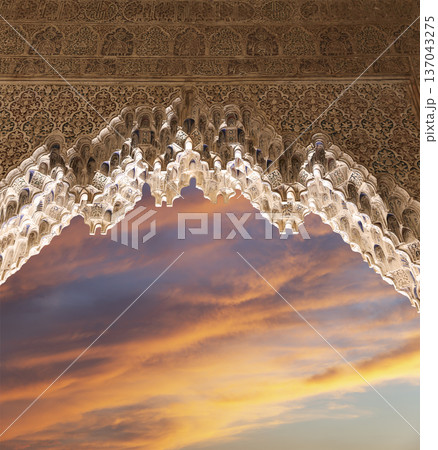 Arches in Islamic (Moorish) style (against the sunset) in Alhambra, Granada, Spain 137043275